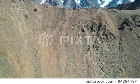 Mountain pass with steep descent and rocks 94884457