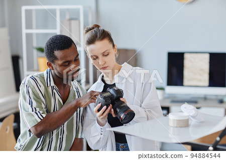 Two Photographers Choosing Images In Camera 94884544