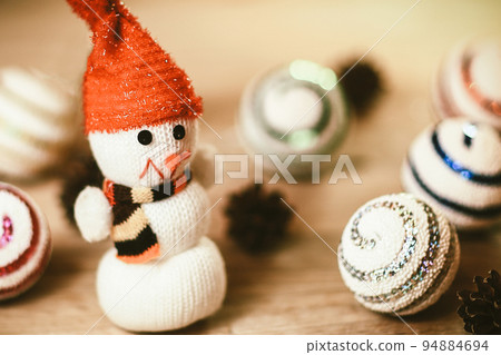toy snowman and gingerbread house at the Christmas table toy snowman and gingerbread house at the Christmas table 94884694