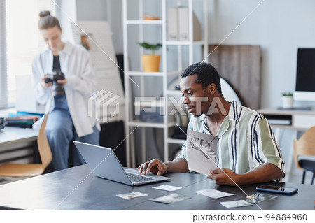 Young Black Photographer Using Laptop Young Black Photographer Using Laptop 94884960