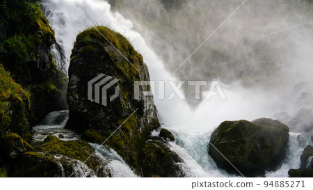 Panoramic view to kleivafossen waterfall at briksdalselva river, Briksdalsbreen glacier, Norway Panoramic view to kleivafossen waterfall at briksdalselva river, Briksdalsbreen glacier, Norway 94885271