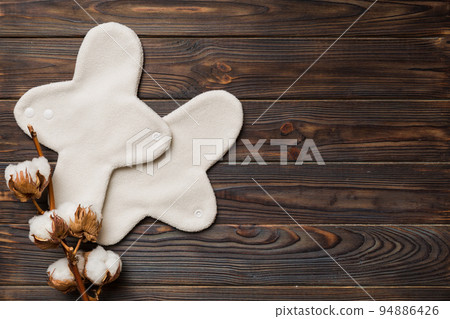 set of colorful bright reusable menstrual pads with cotton flower. zero waste woman periods concept top view with copy space set of colorful bright reusable menstrual pads with cotton flower. zero waste woman periods concept top view with copy space 94886426