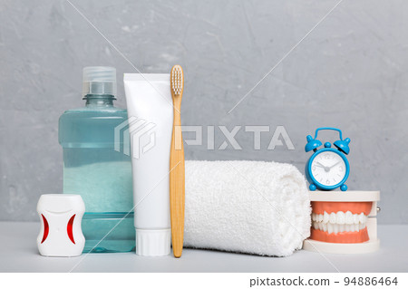 Mouthwash and other oral hygiene products on colored table top view with copy space. Flat lay. Dental hygiene. Oral care kit. Dentist concept 94886464