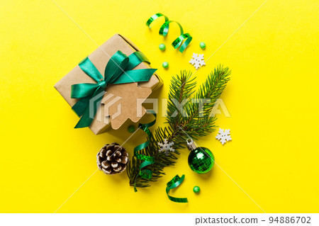 Top view Flat lay Christmas decorations and gift box on colored background with copy space. Christmas or Happy New Year composition Top view Flat lay Christmas decorations and gift box on colored background with copy space. Christmas or Happy New Year composition 94886702