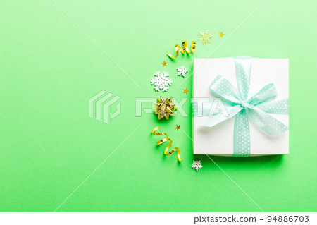 Top view Flat lay Christmas decorations and gift box on colored background with copy space. Christmas or Happy New Year composition 94886703