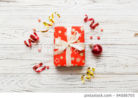 Top view Flat lay Christmas decorations and gift box on colored background with copy space. Christmas or Happy New Year composition 94886705