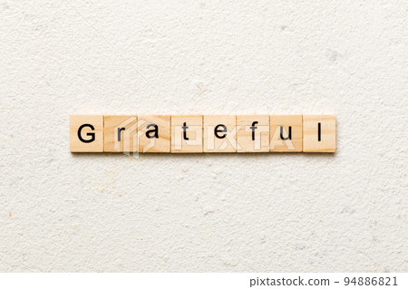 Grateful word written on wood block. Grateful text on table, concept Grateful word written on wood block. Grateful text on table, concept 94886821