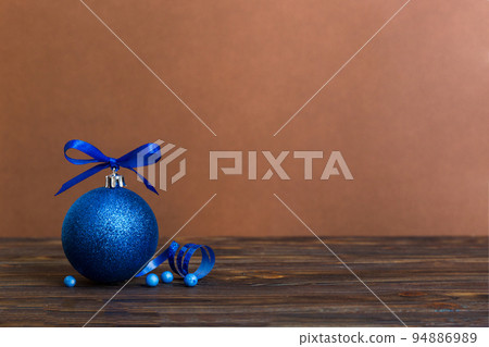 Christmas ball on colored background. decoration bauble with ribbon bow with copy space Christmas ball on colored background. decoration bauble with ribbon bow with copy space 94886989