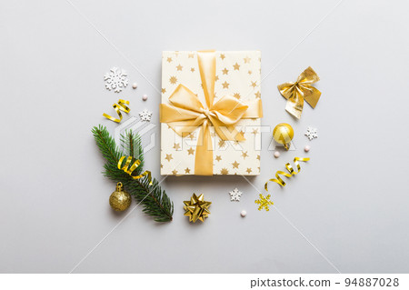 Top view Flat lay Christmas decorations and gift box on colored background with copy space. Christmas or Happy New Year composition 94887028