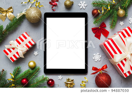 Digital tablet mock up with rustic Christmas decorations for app presentation top view with empty space for you design. Christmas online shopping concept. Tablet with copy space on colored background 94887030