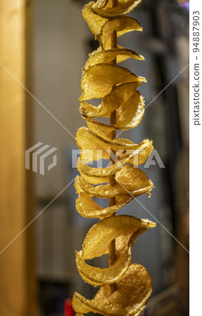 Malaysia, July 10, 2022 - Potato chips freshly fried for sale at night market Malaysia, July 10, 2022 - Potato chips freshly fried for sale at night market 94887903