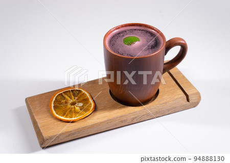 hot cup of mulled red wine, citrus dry orange on wooden board isolated on white hot cup of mulled red wine, citrus dry orange on wooden board isolated on white 94888130