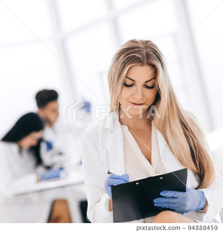 scientist make notes to the clipboard in the clinical laborator scientist make notes to the clipboard in the clinical laborator 94888459