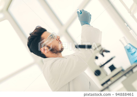 close up. scientist with a medical tube standing in the lab 94888461