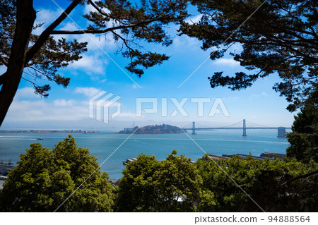 San Francisco view of Oakland Bay bridge and Yerba Buena Island from Coit Tower on a bright sunny summer day. Travelling in the usa NoCal California Nature travel landscape background 94888564