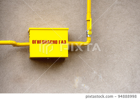 Russian gas box, arm and pipe and text Flammable Gas dirty wall 94888998