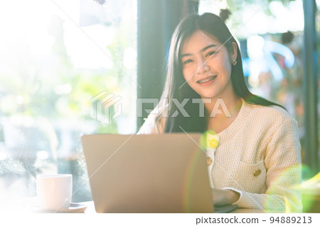 Portrait freelance business beautiful positive smile young asian woman online working with laptop computer at home in the living room indoors or the cafe,Business Lifestyle Portrait freelance business beautiful positive smile young asian woman online working with laptop computer at home in the living room indoors or the cafe,Business Lifestyle 94889213