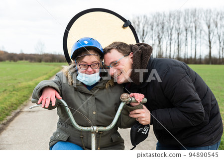 Family portrait of a woman with down syndrome and her brother Family portrait of a woman with down syndrome and her brother 94890545