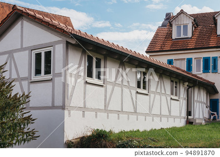 Traditional small house with beautiful outdoor decor facade in Germany. German old brick building house ancient European city German architect Traditional small house with beautiful outdoor decor facade in Germany. German old brick building house ancient European city German architect 94891870
