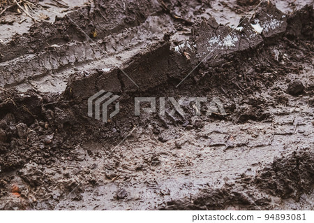Dirty  texture. Wet soggy earth after rain. Mud surface in autumn. Tire marks in dirt. Track for racing 94893081