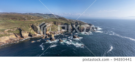 Aerial view of the rocks in the sea at Crohy Head Sea Arch, County Donegal - Ireland. Aerial view of the rocks in the sea at Crohy Head Sea Arch, County Donegal - Ireland. 94893441