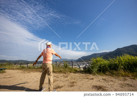 Senior man doing radio calisthenics alone in the morning park Senior man doing radio calisthenics alone in the morning park 94893714
