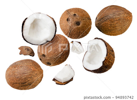 Coconuts, halves and pieces are flying on a white background. Isolated Coconuts, halves and pieces are flying on a white background. Isolated 94893742
