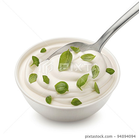 Bowl of sour cream with basil leaves isolated on white background Bowl of sour cream with basil leaves isolated on white background 94894094