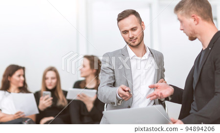 young employees discussing their ideas in the workplace young employees discussing their ideas in the workplace 94894206