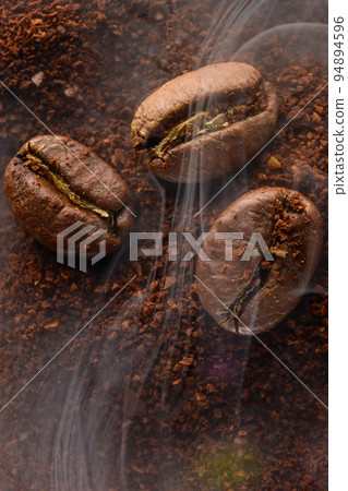 Ground coffee and coffee beans, coffee in light smoke. Ground coffee and coffee beans, coffee in light smoke. 94894596