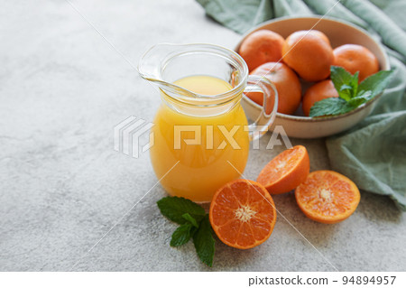 Jug of fresh orange tangerine juice Jug of fresh orange tangerine juice 94894957