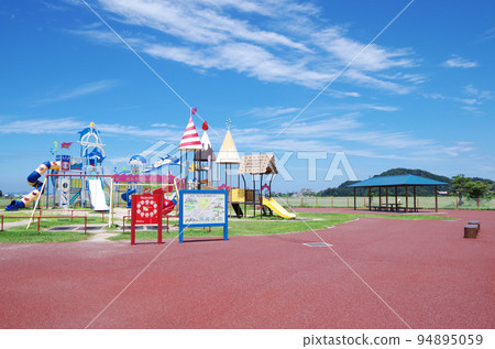 Scenery of a bright and refreshing summer park with colorful playground equipment 94895059