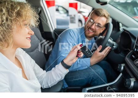 Happy couple in their new car Happy couple in their new car 94895395