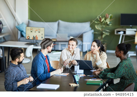 Young colleagues listening to confident businessman explaining his viewpoint Young colleagues listening to confident businessman explaining his viewpoint 94895415