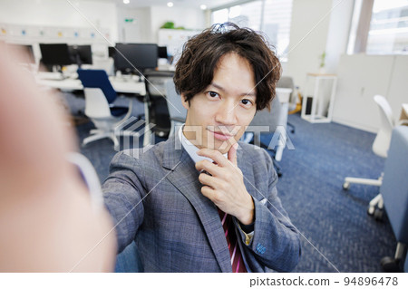A man taking a selfie with a smartphone A man taking a selfie with a smartphone 94896478