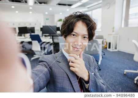 A man taking a selfie with a smartphone A man taking a selfie with a smartphone 94896480