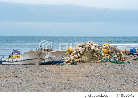 small fishing boats and nets on the seashore small fishing boats and nets on the seashore 94896542
