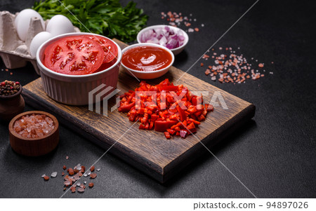 Ingredients for making shakshuka, dishes with fried eggs with tomato sauce, spices and herbs Ingredients for making shakshuka, dishes with fried eggs with tomato sauce, spices and herbs 94897026
