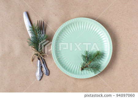 Holiday table setting with branch of christmas tree, empty plate and decorations. New year flat lay food concept 94897060
