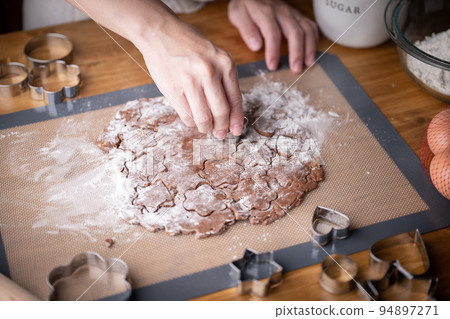 cutting out cookie dough with hands 94897271