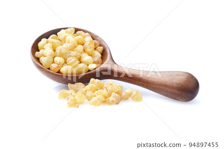 Frankincense resin in wooden spoon on white background 94897455