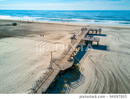Crest beach in Wildwood New Jersey on the Atlantic ocean beach with wooden dock from above 94897805