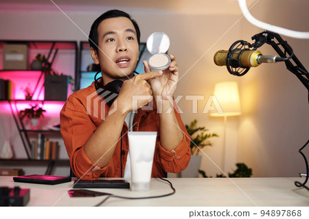 Horizontal medium portrait of modern Asian male beauty blogger making review or advertisment for new cosmetic products Horizontal medium portrait of modern Asian male beauty blogger making review or advertisment for new cosmetic products 94897868