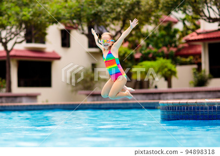 Child in swimming pool on toy ring. Kids swim. 94898318
