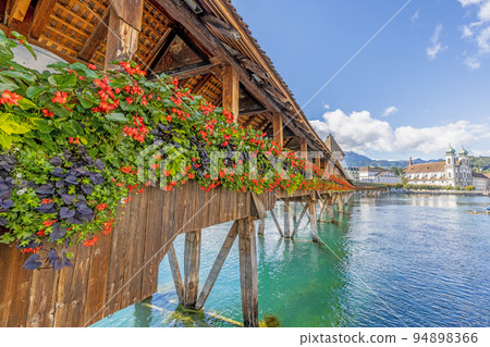 View along the flower-covered Chapel Bridge in Lucerne View along the flower-covered Chapel Bridge in Lucerne 94898366