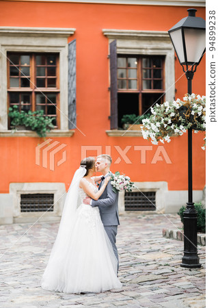 Wedding couple on the nature is hugging each other. Beautiful model girl in white dress. Man in suit 94899238