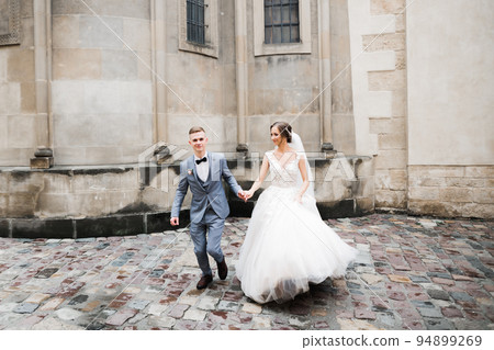 Wedding couple holding hands, groom and bride together on wedding day 94899269