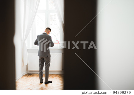 Young handsome man relaxing at his apartment in a hotel after business meeting Young handsome man relaxing at his apartment in a hotel after business meeting 94899279