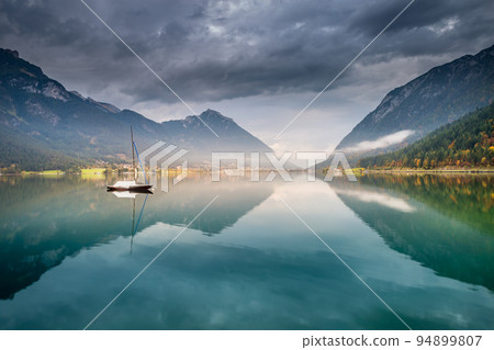 Sailboats in Achensee lake near Innsbruck at peaceful dawn, Tyrol alps, Austria 94899807