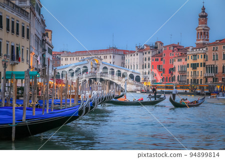 Rialto and ornate Gondolas in Grand Canal pier at sunset, Venice, Italy Rialto and ornate Gondolas in Grand Canal pier at sunset, Venice, Italy 94899814